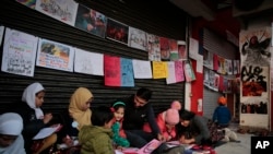 Young girls draw sketches near the protest site in New Delhi's Shaheen Bagh area, Jan. 21, 2020.