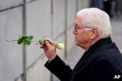 German President Frank-Walter Steinmeier places a flower at the Berlin Wall Memorial in Berlin on Nov. 9, 2024.