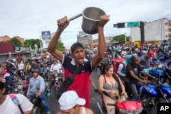 People protest the official election results declaring President Nicolas Maduro the winner of the presidential election, the day after the vote in Caracas, Venezuela, July 29, 2024.