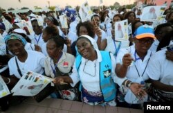 Women sing as they await the arrival of Pope Francis in Maputo, Mozambique, Sept. 4, 2019.