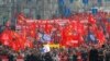 People march with red flags during a rally to mark May Day in Moscow, Russia, May 1, 2018.