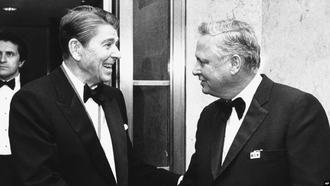 FILE - President Ronald Reagan, left, shakes hands with Barron Hilton on Capitol Hill in Washington, Jan. 26, 1985. Hilton, a hotel magnate, has died. 