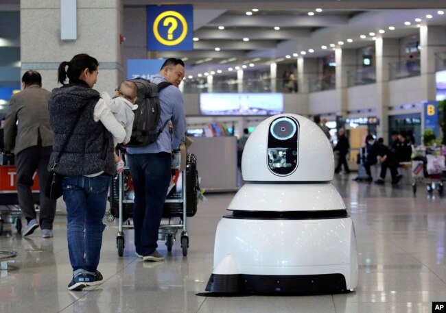 FILE 0 In this April 10, 2017 photo, an LG Electronics cleaning robot moves to clean the floor at the Incheon International Airport in Incheon, South Korea. (AP Photo/Ahn Young-joon)