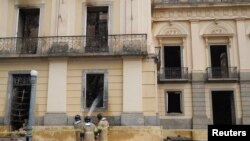 Firefighters spray water on the National Museum of Brazil after a fire in Rio de Janeiro, Brazil, Sept. 4, 2018. 