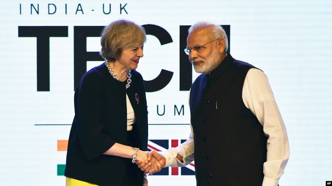 British Prime Minister Theresa May is greeted by her Indian counterpart, Narendra Modi, at the India-U.K Tech Summit in New Delhi, Nov. 7, 2016. 