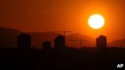 The sun sets over the University District in Seattle, Washington, May 13, 2023. 