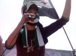 Syrian refugee Anas Allouz speaks during a protest outside the Syrian Embassy in Jordan in 2012. (Submitted photo)