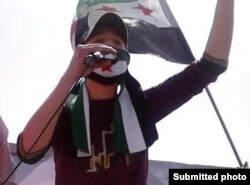 Syrian refugee Anas Allouz speaks during a protest outside the Syrian Embassy in Jordan in 2012. (Submitted photo)