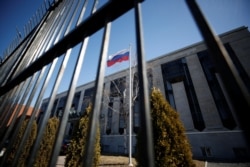 FILE - A flag is pictured outside the Russian embassy in Ottawa, Ontario, Canada, March 26, 2018.