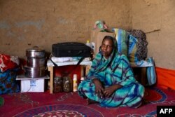 FILE—26-year-old Sudanese refugee Hamra Adam Mohammed poses for a photo inside the shelter she built in the Farchana refugee camp, on April 7, 2024.