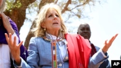 US first Lady Jill Biden, left, greets women of the Maasai community as they explain the drought situation in Ngatataek, Kajiado Central, Kenya, Feb. 26, 2023. 