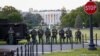 Law enforcement officers from Calvert County Maryland Sheriff's Office standing on the Ellipse, area just south of the White House in Washington, as they watch demonstrators protest