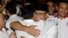 Gubernatorial candidate Anies Baswedan, center right, hugs his running mate Sandiaga Uno during a press conference in Jakarta, Indonesia, April 19, 2017. 