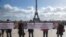 FILE - Activists holding banners at Trocadero square in Paris, France, Feb. 11, 2020, call for the release of scientists Fariba Adelkhah and Roland Marchal, both imprisoned in Iran. Marchal was released earlier this year.