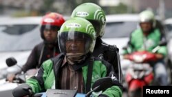 Pengemudi dan penumpang Go-Jek di Jakarta, 18 Desember 2015. (Foto:dok)