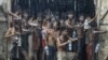 Migrants, who were found at sea on a boat, collect rainwater during a heavy rain fall at a temporary refuge camp near Kanyin Chaung jetty, outside Maungdaw township, northern Rakhine state, Myanmar.