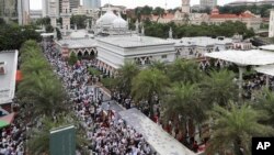 Protesters rally near a mosque to celebrate the government's decision not to ratify a U.N. anti-discrimination convention, in Kuala Lumpur, Malaysia, Dec. 8, 2018. Thousands of Malaysian Muslims are rallying against any attempt to strip ethnic Malay majority of their privileges.