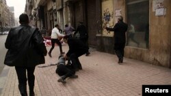 FILE - Activist Shaimaa Sabbagh is shown collapsed on the ground after she was shot during a protest in Cairo, Egypt, Jan. 24, 2015.