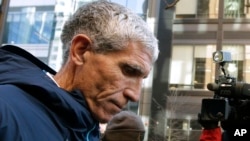 FILE - William "Rick" Singer, founder of the Edge College & Career Network, departs federal court in Boston after pleading guilty to charges in a nationwide college admissions bribery scandal, March 12, 2019.