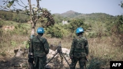 Rwandan peacekeepers of the U.N. Multidimensional Integrated Stabilization Mission in the Central African Republic monitor the arrival of rebel groups on National Road 2 north of Bangui, Central African Republic, Dec. 25, 2020.