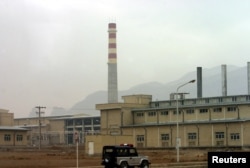A security car passes in front of the Natanz nuclear facility located 300 kilometers (185 miles) south of Tehran, Nov. 20, 2004.