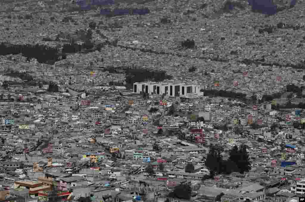 The Social Security hospital, which cares for COVID-19 patients, stands tall amid homes on the south side of Quito, Ecuador, Aug. 17, 2020.