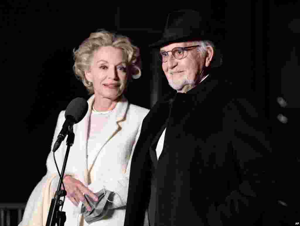 Jean-Louis Livi and Caroline Silhol arrive to attend a screening of the Oscars on Monday April 26, 2021 in Paris, France. (AP Photo/Lewis Joly, Pool)