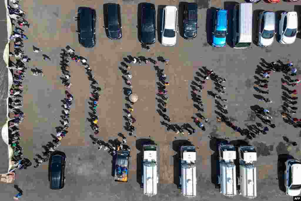 This image from above shows people lining up to receive the Sinovac COVID-19 coronavirus vaccine in Jakarta, Indonesia.