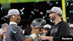 2025 Philadelphia Eagles' Jalen Hurts and head coach Nick Sirianni celebrate with the Vince Lombardi Trophy after winning Super Bowl LIX.