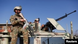 Afghan security forces inspect the site of an attack in a U.S. military air base in Bagram, north of Kabul, Afghanistan December 11, 2019. REUTERS/Mohammad Ismail