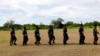 FILE - Filipino soldiers march in Philippine occupied Thitu island in disputed South China Sea, April 21, 2017. 