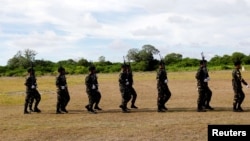FILE - Filipino soldiers march in Philippine occupied Thitu island in disputed South China Sea, April 21, 2017. 