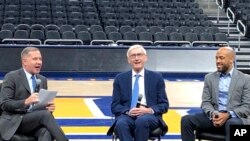 Wisconsin Gov. Tony Evers, center, and Lt. Gov. Mandela Barnes, right, take questions Tuesday, Jan. 7, 2020 from Democratic National Convention chief officer Joe Solmonese, left,on the floor of the Fiserv Forum in Milwaukee at a media walk-through event.