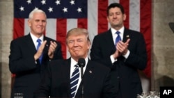 President Donald Trump, flanked by Vice President Mike Pence, left, and House Speaker Paul Ryan arrives on Capitol Hill in Washington for his address to a joint session of Congress, Feb. 28, 2017.