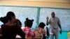 Students listen to school Director Jean Marc Charles at the Lycée school, which reopened about a week earlier than other schools in Petion-Ville, Haiti, Nov. 28, 2019. 