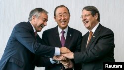 FILE - U.N. Secretary-General Ban Ki-moon, center, poses for photographers with Turkish Cypriot leader Mustafa Akinci, left, and Cypriot President Nicos Anastasiades during the Cyprus reunification talks in the Swiss mountain resort of Mont Pelerin, Switzerland, Nov. 7, 2016.