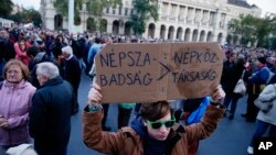 Demonstrators gather in front of the Parliament building to show their solidarity with the Hungarian political daily Nepszabadsag in Budapest, Hungary, Saturday, Oct. 8, 2016. 