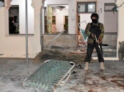 Pakistani police officer stands guard at the site of bomb explosion in a mosque in Quetta, Pakistan, Jan. 10, 2020.