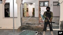 FILE - A Pakistani police officer stands guard at the site of bomb explosion at a mosque in Quetta, Pakistan, Jan. 10, 2020.