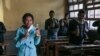 Students drink from bottles of Covid Organics, a herbal tea touted by Madagascar President Andry Rajoelina as a powerful remedy against COVID-19, at a high school in Antananarivo, April 23, 2020.