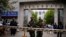 FILE - Paramilitary policemen stand guard in front of Urumqi No. 5 middle school after Thursday's attack in downtown Urumqi, Xinjiang, Uighur Autonomous Region.