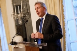 FILE - British Ambassador Kim Darroch, who has since resigned as London's envoy to the U.S., speaks at an Afternoon Tea at the British Embassy in Washington, Jan. 18, 2017.
