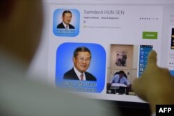 FILE - A Cambodian man looks at a page of Prime Minister Hun Sen's app on a computer in Phnom Penh, Jan. 12, 2016.