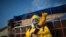 A health worker stands in the Sambadrome as he sprays insecticide to combat the Aedes aegypti mosquitoes that transmit the Zika virus, in Rio de Janeiro, Brazil, Jan. 26, 2016. 
