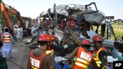 A rescue team works on the site of a deadly accident involving two buses, in Khanpur, Rahim Yar Khan district, Pakistan, Oct. 17, 2016.