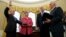 President Donald Trump watches as Vice President Mike Pence administers the oath of office to Attorney General Jeff Sessions, accompanied by his wife Mary, Feb. 9, 2017, in the Oval Office of the White House in Washington.