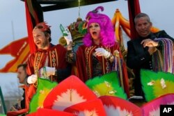 Actor Charlie Day and his wife actress Mary Elizabeth Ellis throw beads in the Krewe of Orpheus along the Uptown parade route during Mardi Gras celebrations in New Orleans, Feb. 24, 2020.
