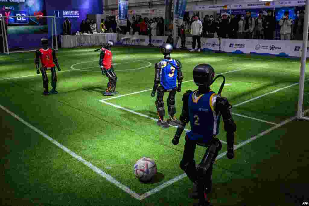 Robots from Booster Robotics play football during the Global Developer Conference, organized by the Shanghai AI Industry Association, in Shanghai.