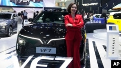 Vu Dang Yen Hang, chief executive officer of VinFast Thailand, poses in front of its electric vehicle VF7 during the 45th Bangkok Motor Show in Nonthaburi, Thailand, March 26, 2024.