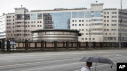 FILE - A man walks past the building of the Main Directorate of the General Staff of the Armed Forces of Russia, also know as Russian military intelligence service in Moscow, Russia. 